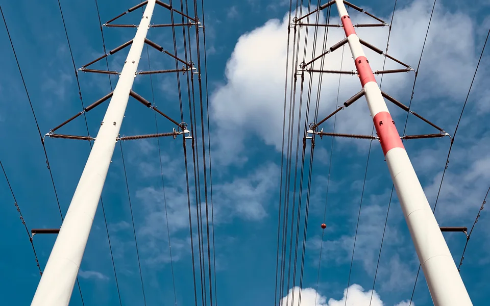Modern high-voltage transmission infrastructure against a clear sky