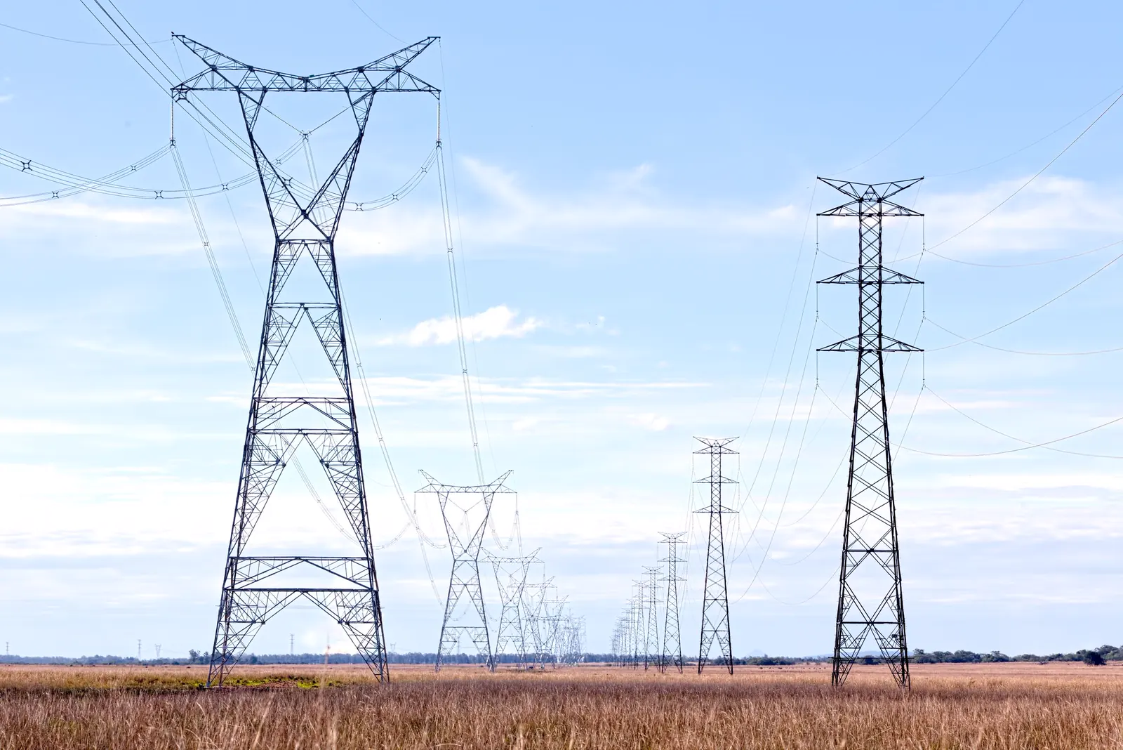 High-voltage transmission lines spanning a wide landscape